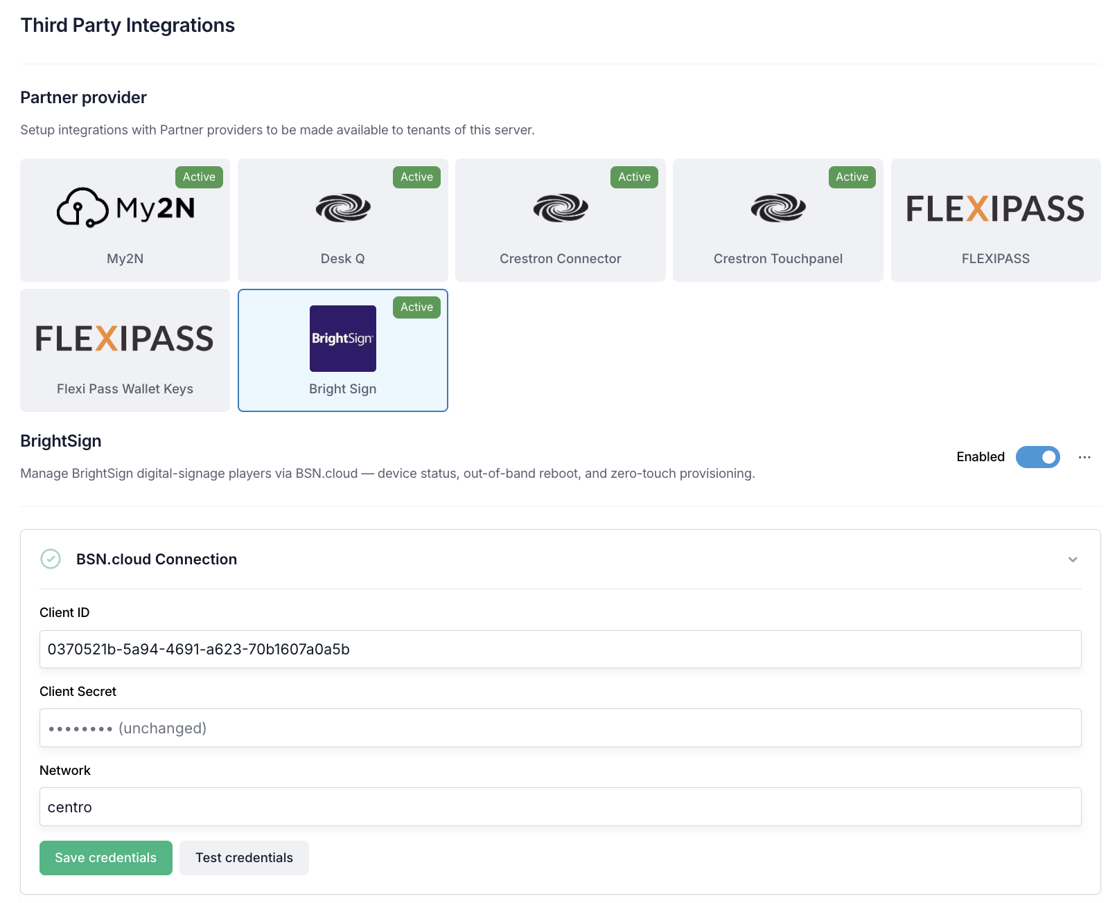 The BrightSign integration settings — the Partner provider grid with the BrightSign tile selected, and the BSN.cloud Connection panel with Client ID, Client Secret and Network fields plus Save credentials and Test credentials buttons.